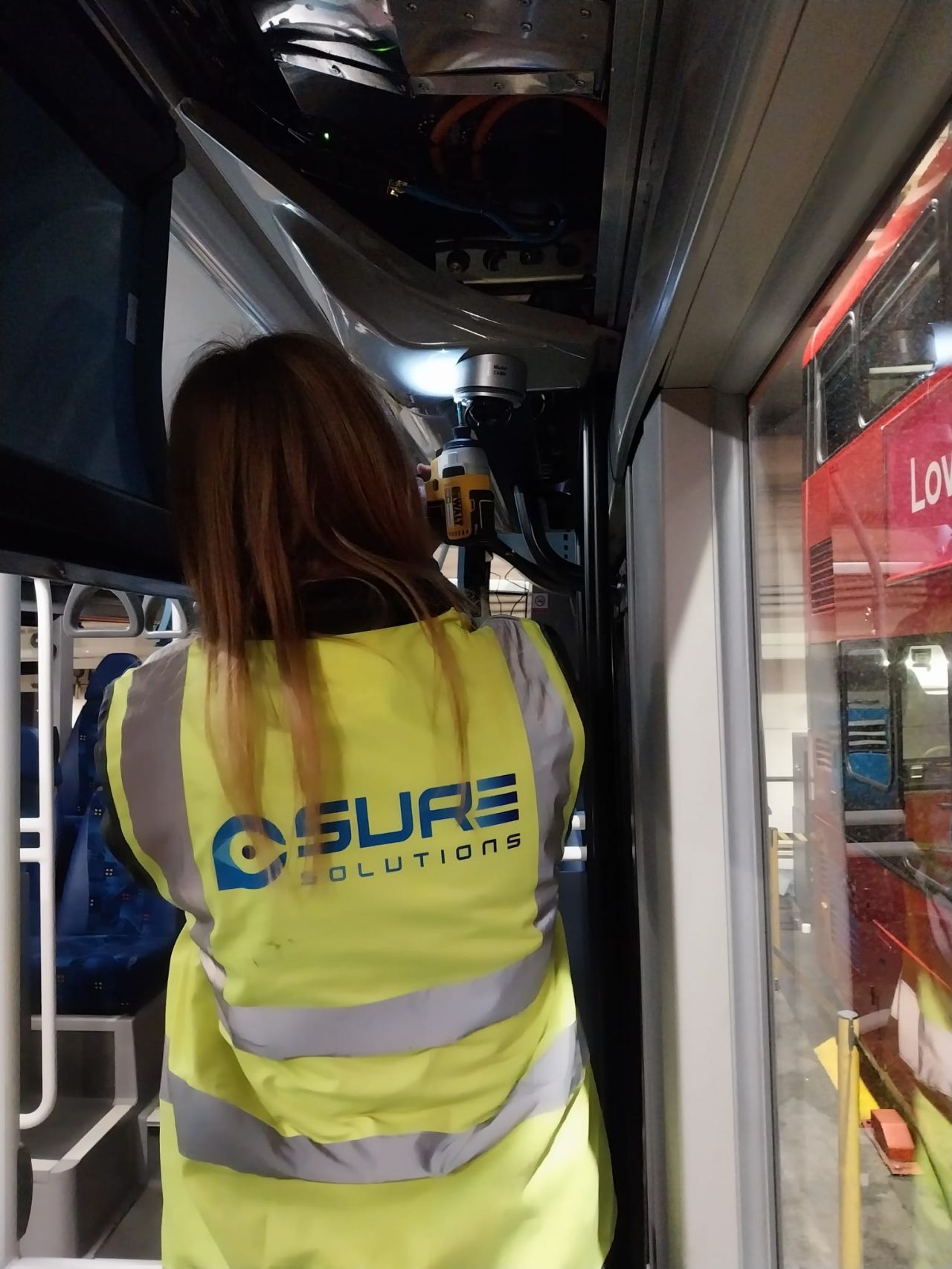 A SURE engineer fitting a camera inside a bus
